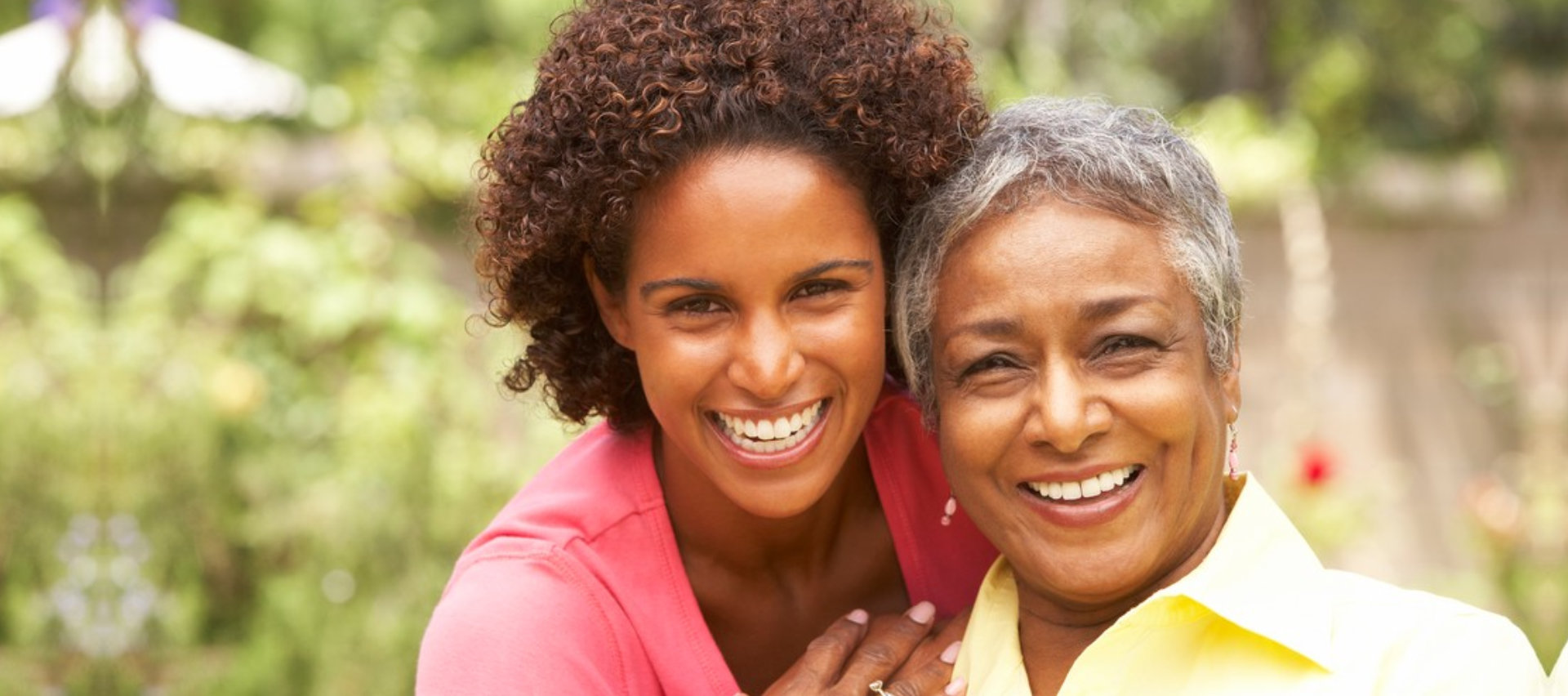 female caregiver and senior woman are smiling