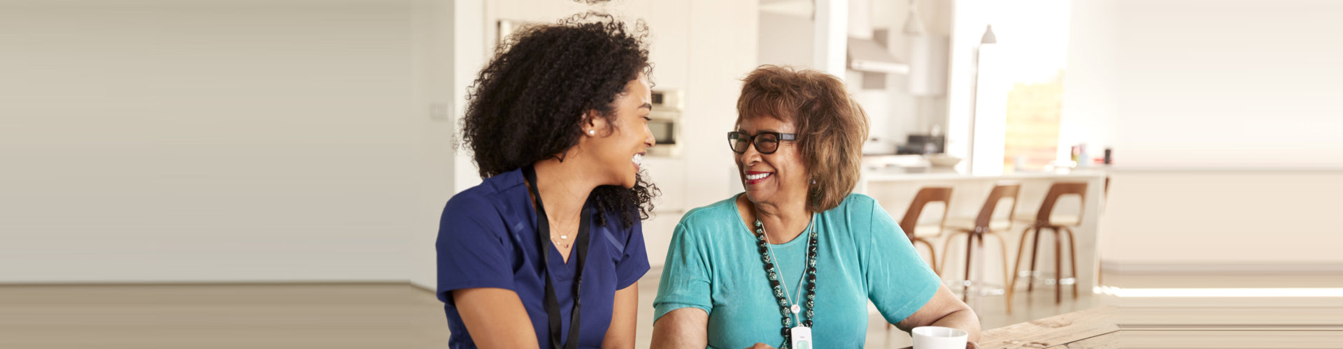 caregiver and senior woman having a conversation