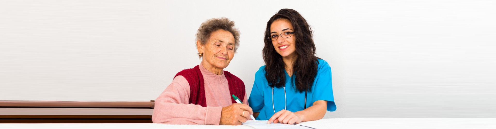 an elderly woman signing