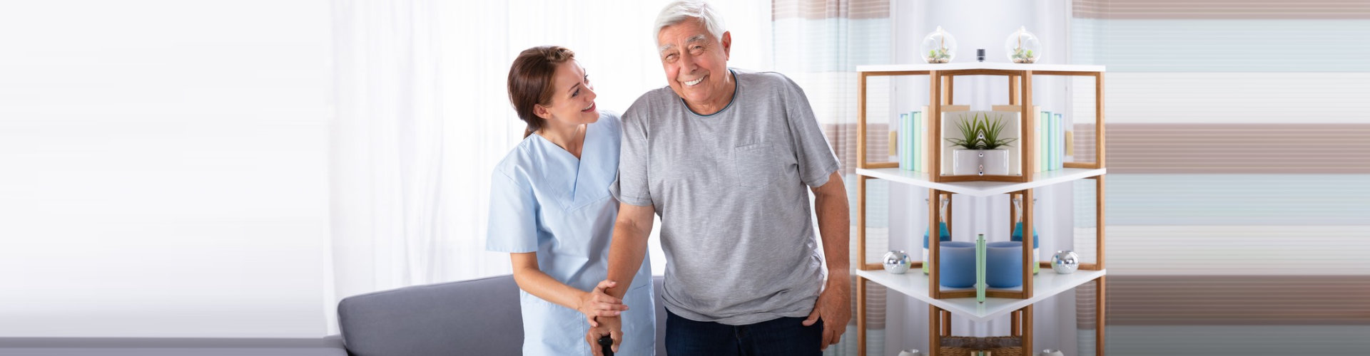 caregiver and senior man are smiling