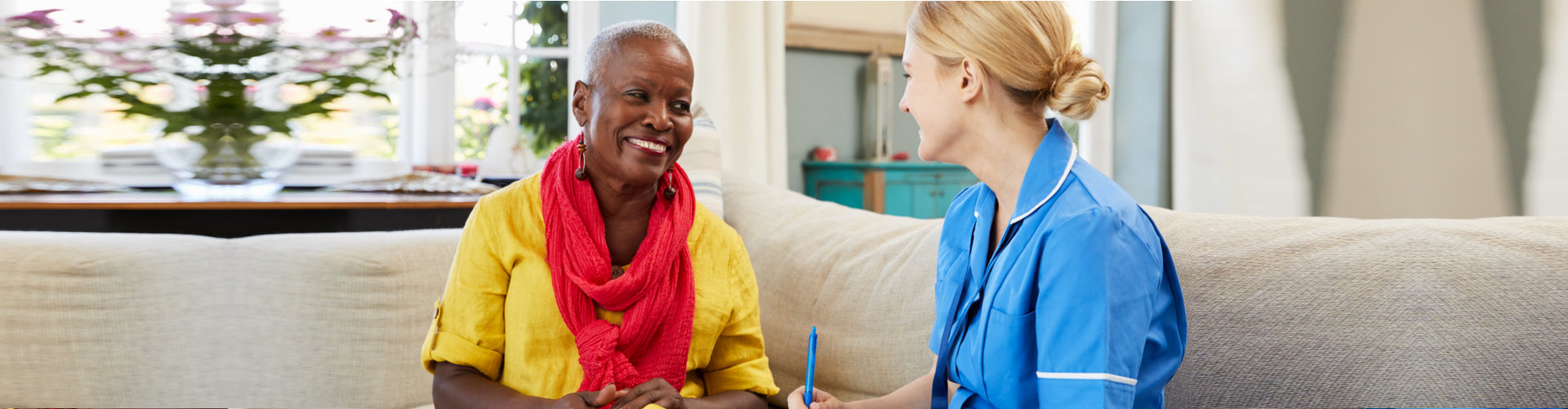 nurse and senior woman having a conversation